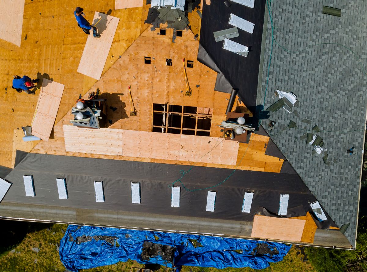 Removal of old roof and replacement roofs with new roof shingle being applied home roof construction all new materials