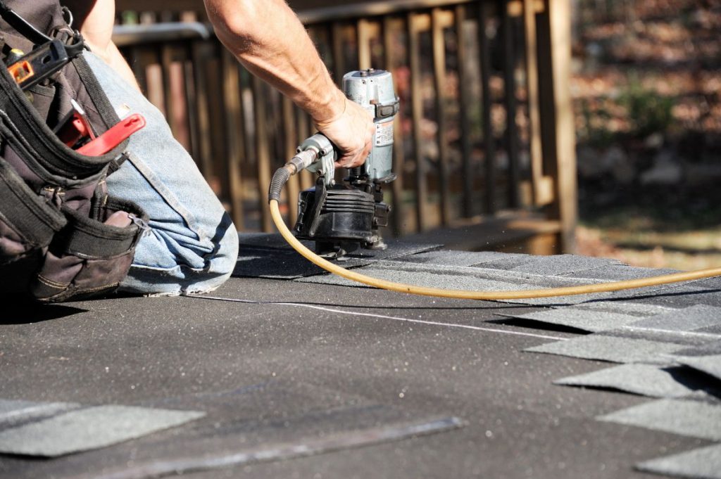 nail gun to install shingle to repair roof
