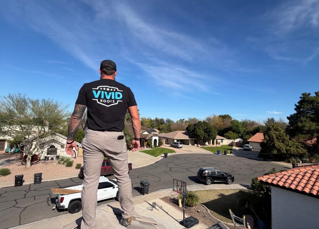 Vivid Roofs team member on a roof, with the logo on the t-shirt